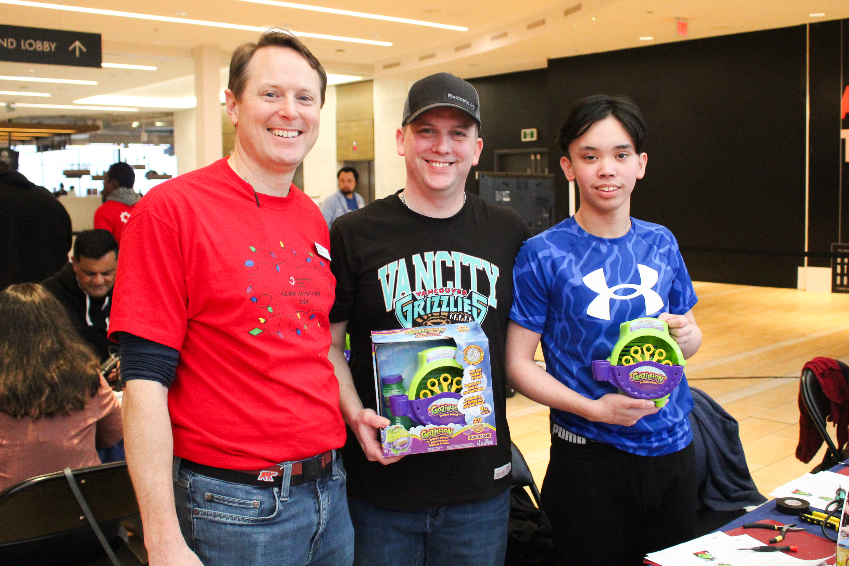 Justin with a man and a youth who had adapted a toy.