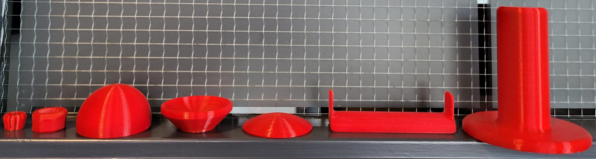 7 red 3D printed joystick toppers for the Oak Joystick.